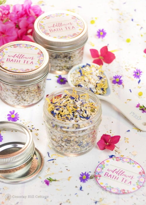 Wildflower Bath Tea Recipe for your self care beauty regimen. This natural herbal skin care recipe is perfect for self care any time of the year. A guest post from Irena of Country Hill Cottage, this indulgent herbal bath tea is made using a combination of herbs & botanicals, natural essential oils and skin soothing oatmeal & Dead Sea salt. This fragrant wildflower bath tea is a great way to relax and care for your skin. Plus it's perfect for homemade gifts with Valentine's Day right around the corner!