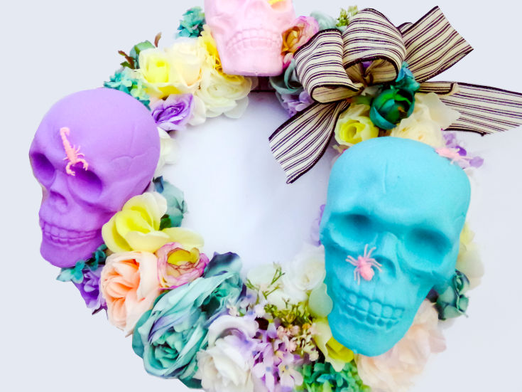 skulls and flowers on diy halloween wreath with dollar tree supplies