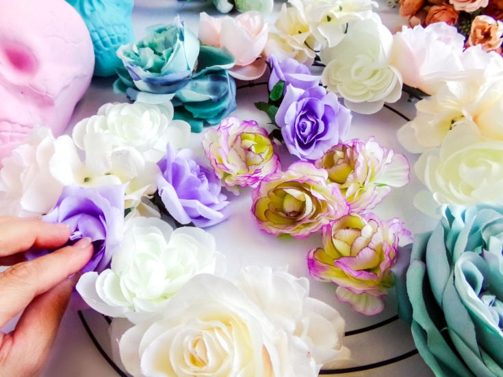 attaching flowers to dollar tree diy halloween wreath with skulls